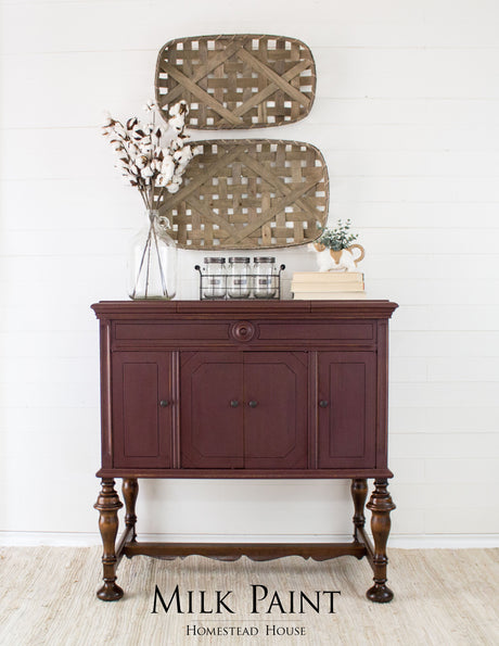Dark wood sideboard with baskets, finished in Homestead House Cranberry Milk Paint.