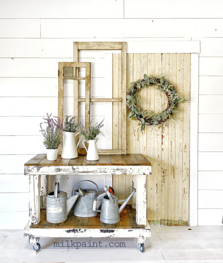 Rustic cart with pitchers, potted lavender, and vintage window frames painted Creamy by Old Fashioned Milk Paint.