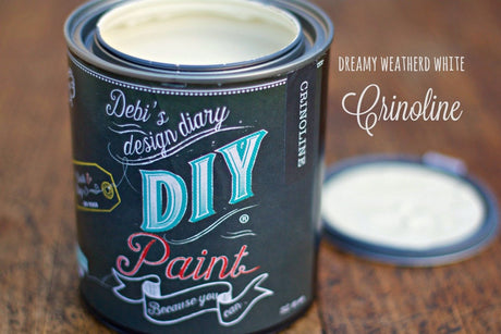 Open can of Crinoline DIY Paint by DIY Paint Co. with lid off on a wooden surface.