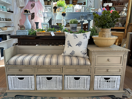 Beige bench with striped cushion, bird pillow, and drawers painted in Crockery DIY Cottage Color by DIY Paint Co.
