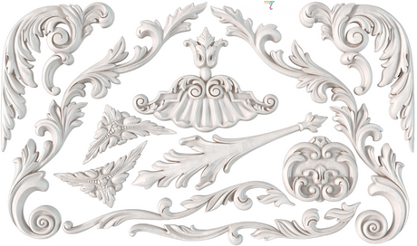 White wood carvings made using I.O.D. Dainty Flourishes Mould by Iron Orchid Designs on a white background.