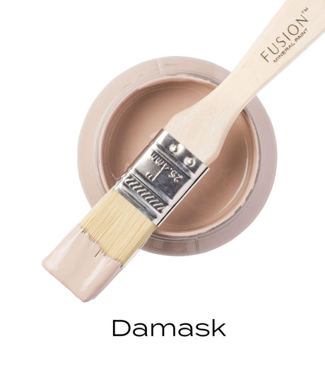 Open Damask Fusion Mineral Paint jar with paintbrush resting on top, bristles dipped in matte finish paint.