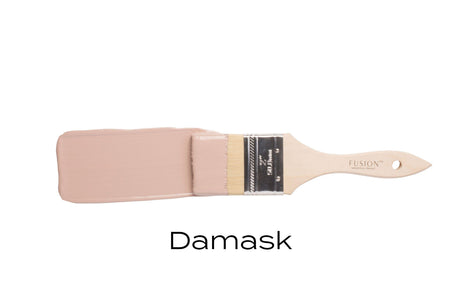 Brush with light mauve Damask Fusion Mineral Paint on bristles, labeled below in bold black text.