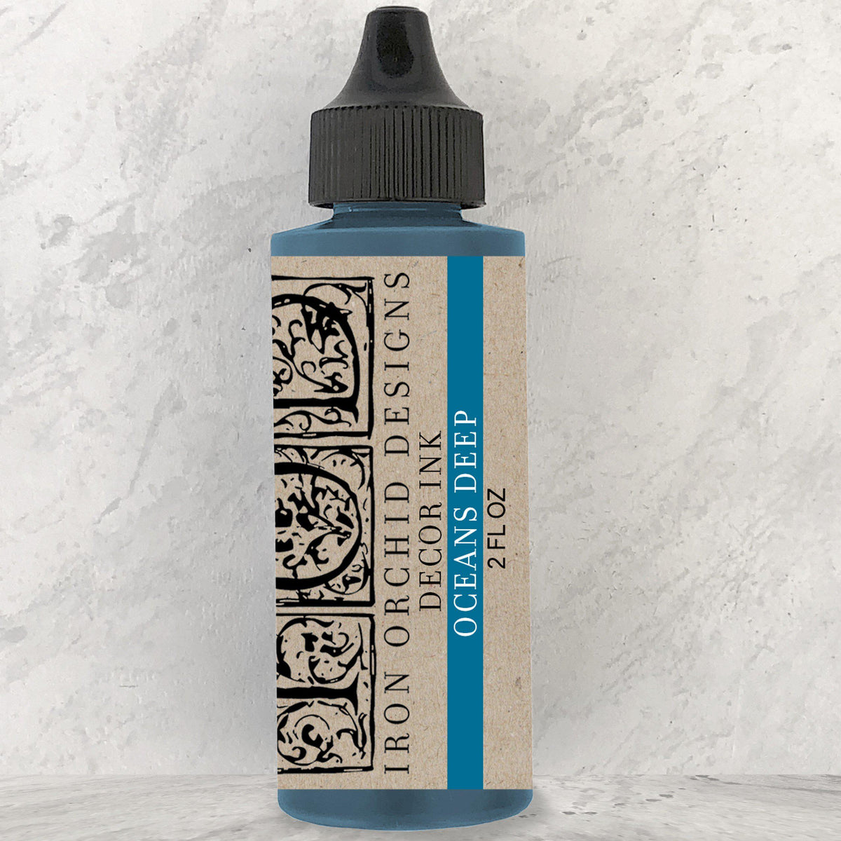 I.O.D. Decor Ink 2 fl oz bottle, Oceans Deep color, standing upright on a light surface.