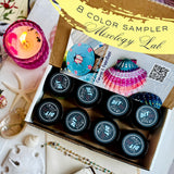 DIY Paint Co. 8-Color Mixology Lab Sampler (2025 Summer) open with paints, next to a candle and seashells.