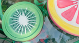Round kiwi-painted object from DIY Paint Co.’s Mixology Lab Sampler Box beside a grapefruit lookalike on glass.
