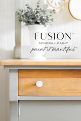 Fusion Mineral Paint—Eucalyptus text, wooden drawer with round knob, and white vase holding eucalyptus.