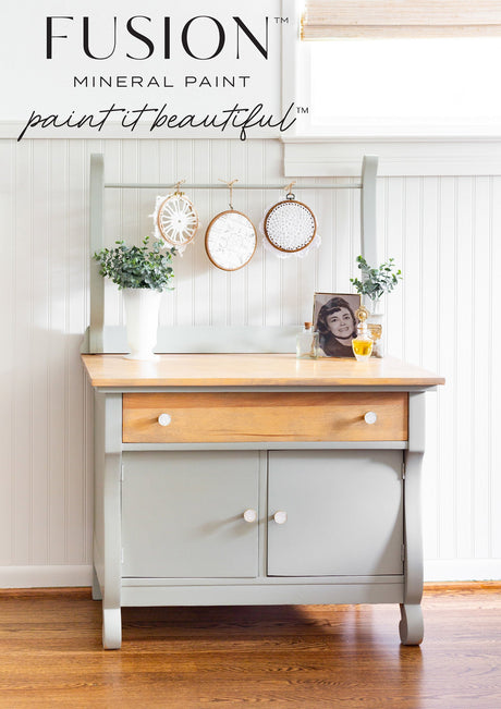 Light gray and wood sideboard with framed art, eucalyptus, and decor; “Eucalyptus Fusion Mineral Paint” above.