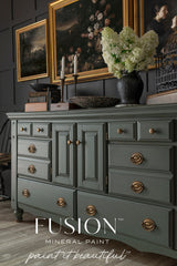 Everett sideboard painted with Everett by Fusion Mineral Paint, brass handles, topped with flowers and art above.