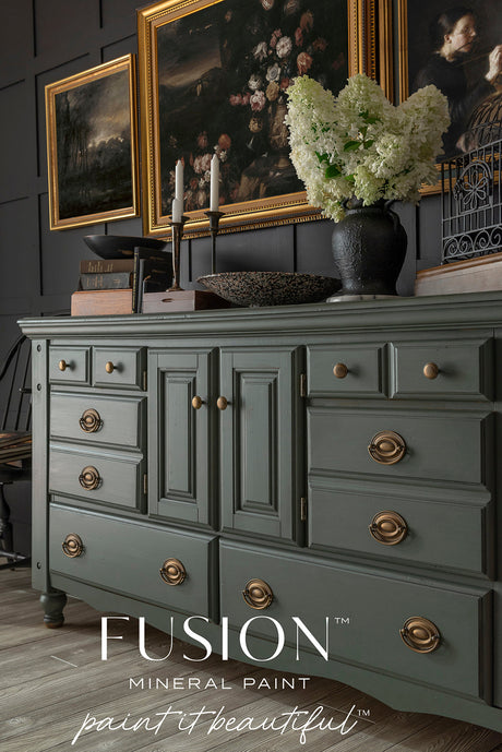 Everett sideboard painted with Everett by Fusion Mineral Paint, brass handles, topped with flowers and art above.