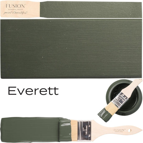 Paintbrush with olive green Everett by Fusion Mineral Paint, alongside swatch and open can of the same paint.