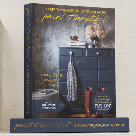 The Fusion Mineral Paint “Everything You Need to Know to Paint in Beautiful Book” displayed upright on its spine.