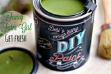 Open can of Fancy Farmgirl DIY Paint by DIY Paint Co. with brush and lid nearby.