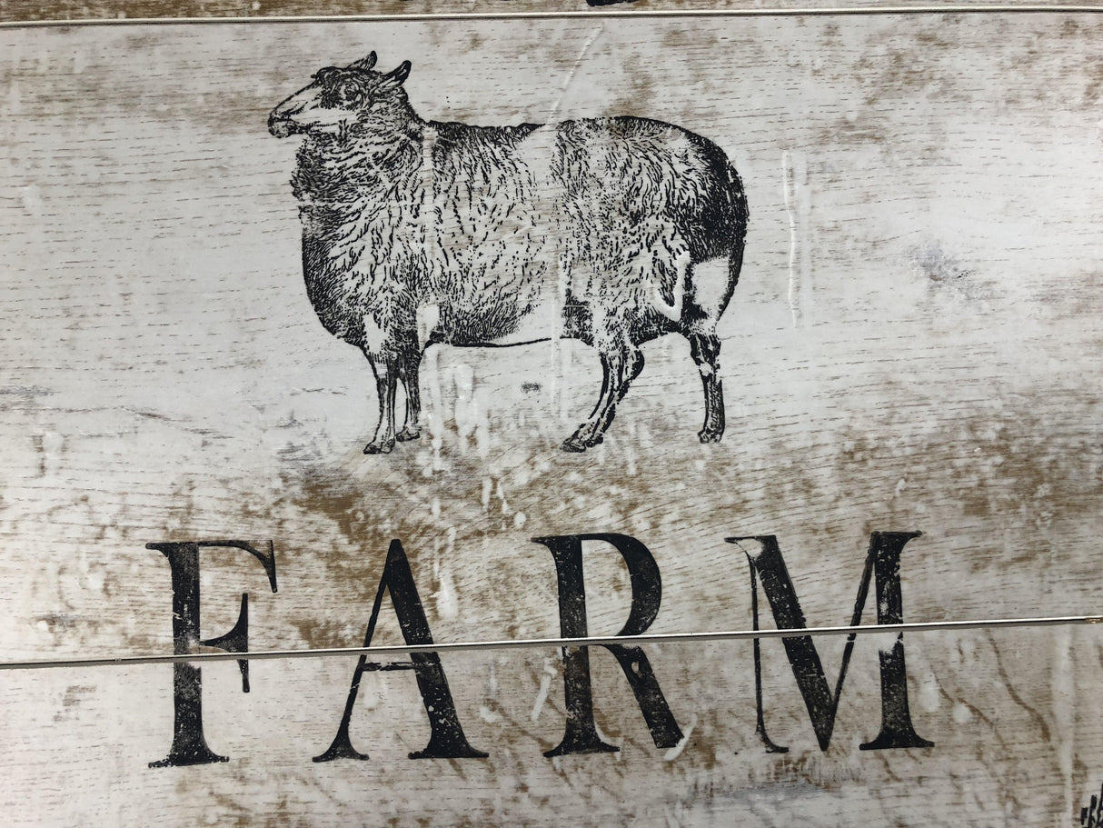 Black sheep illustration above the word “FARM” from Farm Animals Stamp by IOD.