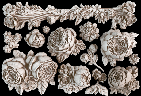 Sepia floral carvings created with the Felicite Mould by IOD against a black background.