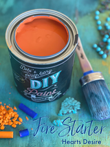Open can of Fire Starter DIY Paint by DIY Paint Co. with blue brush and pigments nearby.