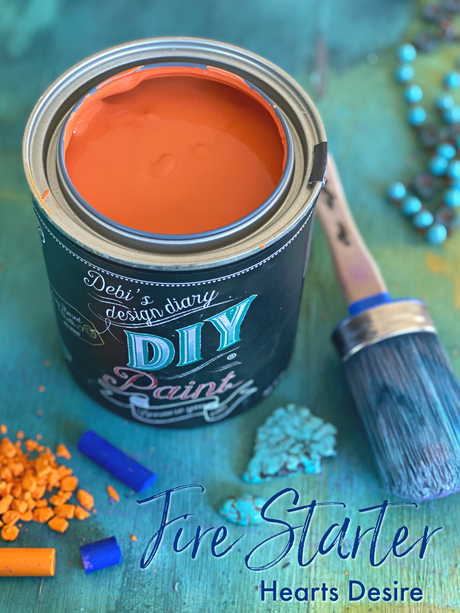 Open can of Fire Starter DIY Paint by DIY Paint Co. with blue brush and pigments nearby.