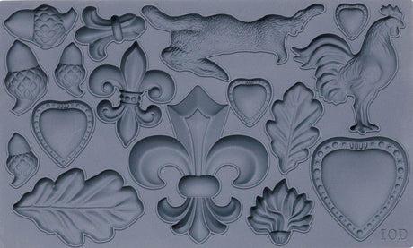 Fleur-de-lis Mould by I.O.D. in gray silicone with hearts, leaves, acorns, rabbit, rooster, and fleur-de-lis shapes.