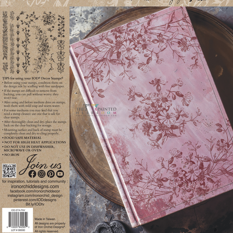 Pink floral journal next to I.O.D. Flora & Vine Stamp instructions and botanical illustrations.