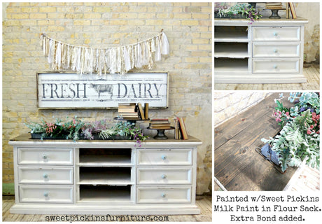 White sideboard with rustic top, floral decor, and Fresh Dairy sign in Flour Sack by Old Fashioned Milk Paint.