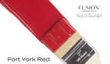 Brush with Fusion Mineral Paint Fort York Red applied on a white surface.
