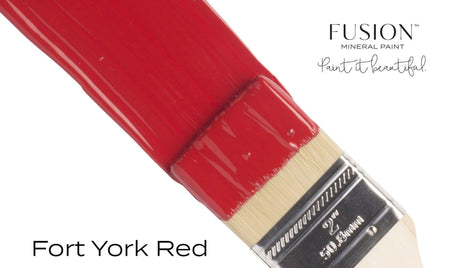 Brush with Fusion Mineral Paint Fort York Red applied on a white surface.