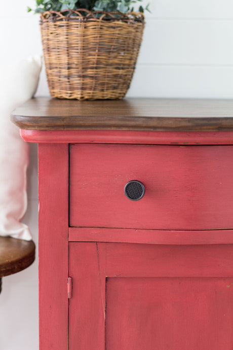 Cabinet in Homestead House Fort York Red Milk Paint with black knob, topped with a wicker basket.