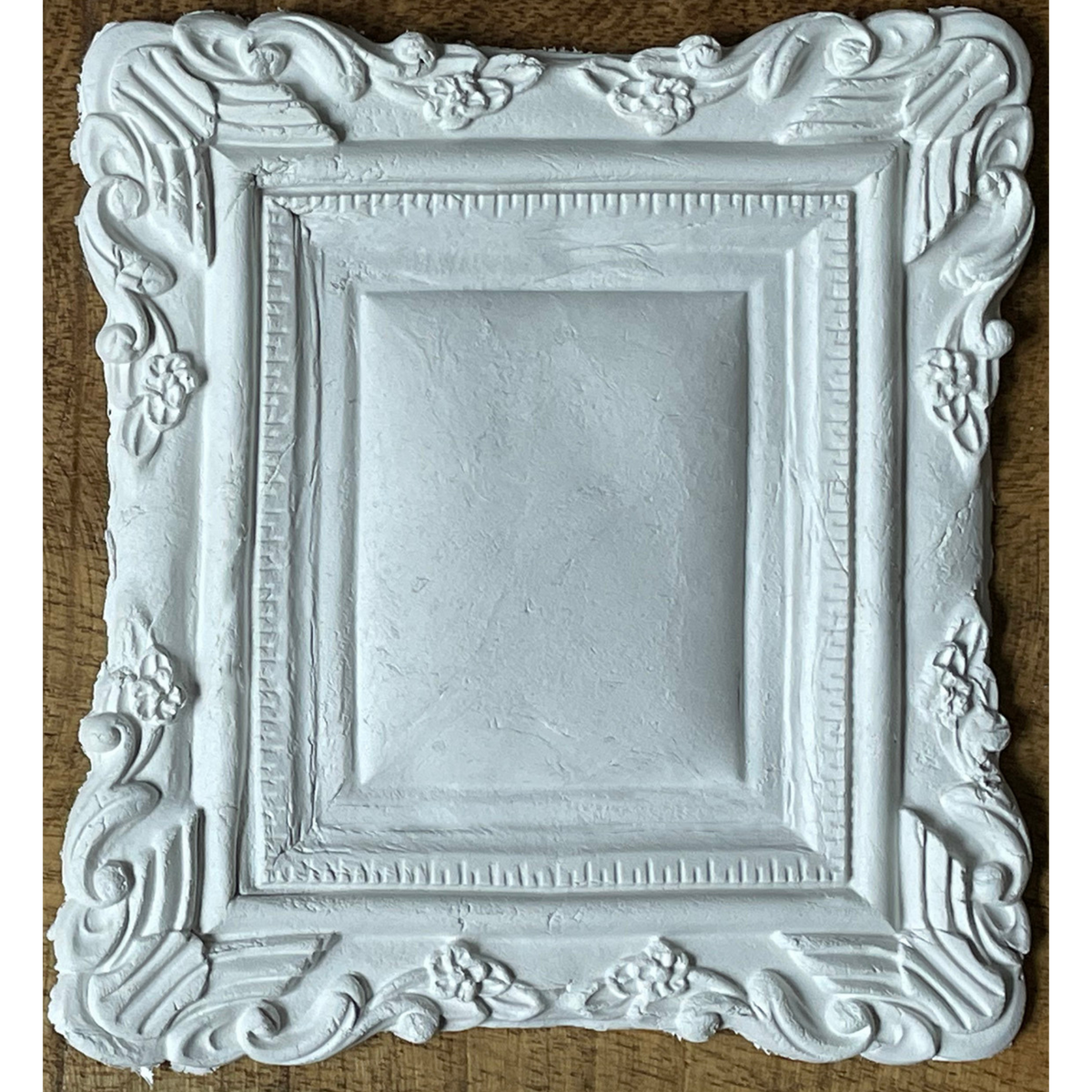 Ornate white frame with floral details made using I.O.D. Frames 2 Mould.