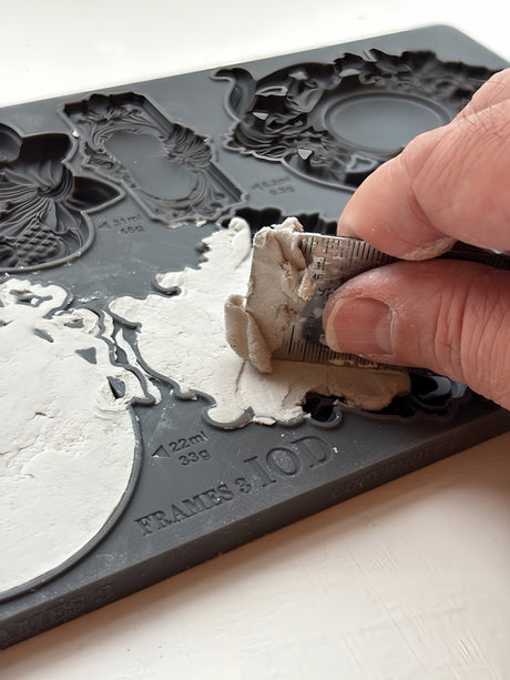 Hand pressing white clay into IOD Frames 3 Mould to create ornate vintage-style mini frames. Brand: I.O.D.