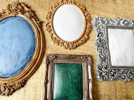Four I.O.D. Frames Mould air dry clay frames arranged on a wood surface.