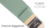 Paintbrush with green French Eggshell Fusion Mineral Paint by Fusion Mineral Paint on white background.