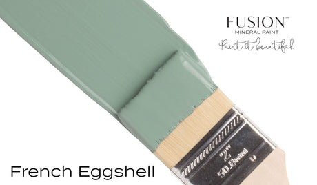 Paintbrush with green French Eggshell Fusion Mineral Paint by Fusion Mineral Paint on white background.