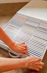 Fusion Briefcase Swatch Box Set by Fusion Mineral Paint opened to show rows of colorful paint swatches inside.