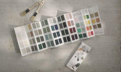 Fusion Mineral Paint True to Color Card 2024, paintbrushes, and brochure on a textured surface.