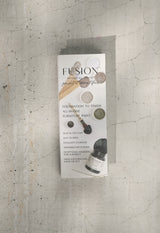 Fusion Mineral Paint box with True to Color Card (2024) and paint chips displayed on cracked concrete.