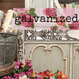 Ornate furniture with Old Fashioned Milk Paint Galvanized finish, metal bucket, flowers, and books displayed.