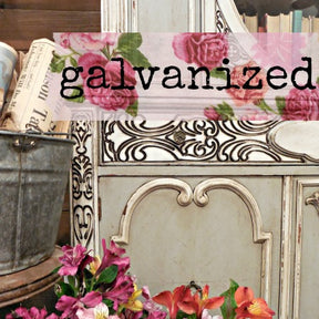 Ornate furniture with Old Fashioned Milk Paint Galvanized finish, metal bucket, flowers, and books displayed.