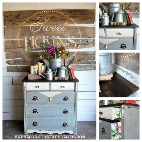 Blue dresser painted in Old Fashioned Milk Paint, with books, flowers, and metal watering cans on top.