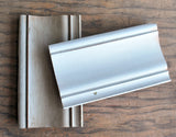 Two wood molding samples finished with Old Fashioned Milk Paint Galvanized – Sweet Pickins Milk Paint on a table.