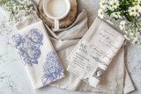 Milk on wood, white daisies, and Garden Bouquet Stamp by IOD on a light textured surface.