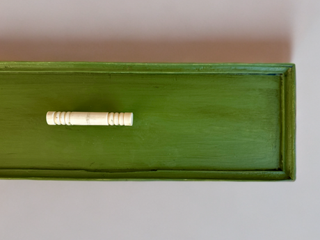 Green wooden drawer painted with DIY Paint Co. Garden Sage Cottage Color, white handle, top view.