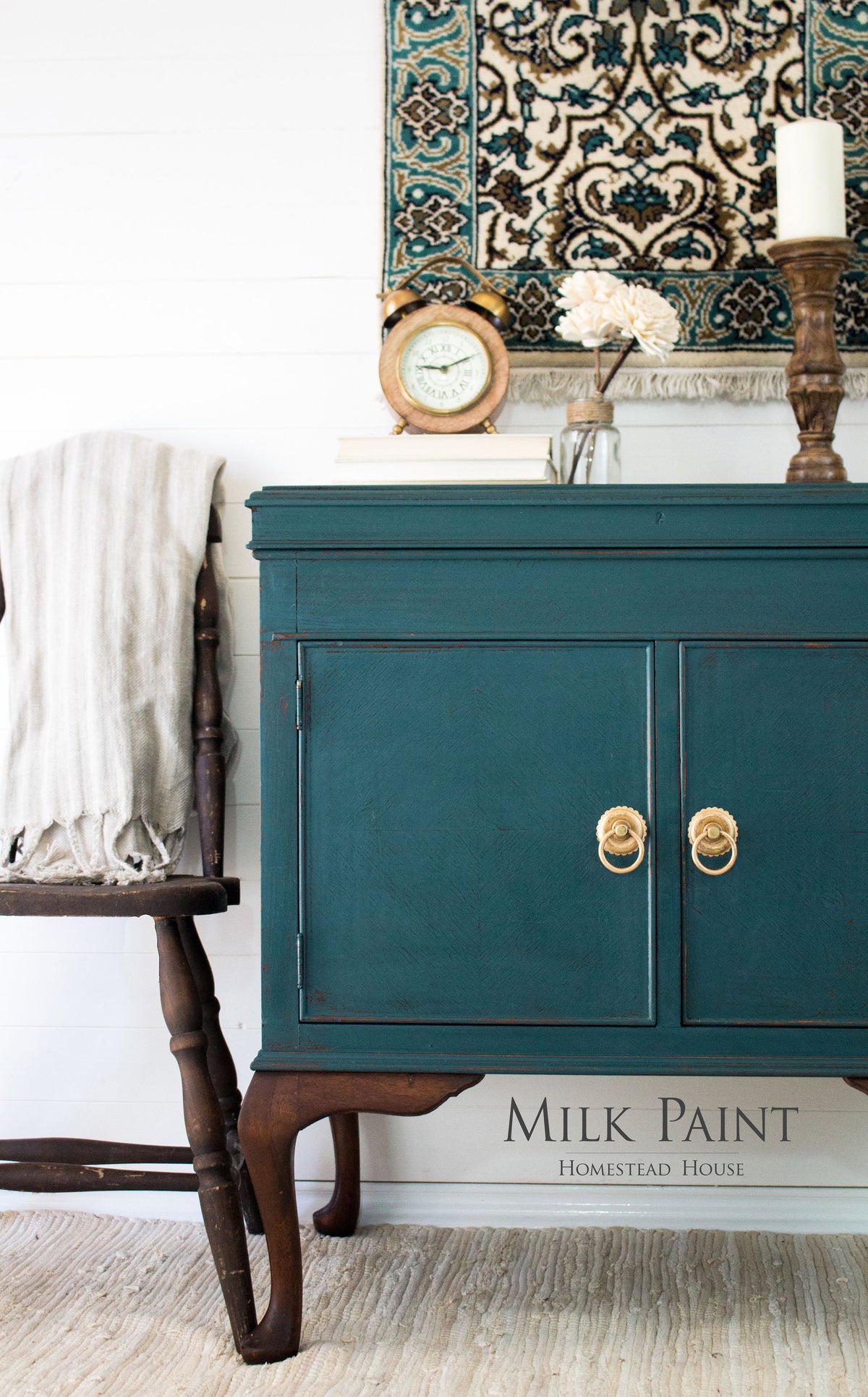 Teal sideboard in Homestead House Gaspe Green Milk Paint with gold handles and vintage decor on a patterned rug.