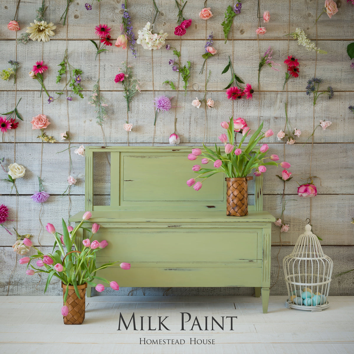 Green furniture painted with Gatineau Milk Paint by Homestead House, pink tulips, birdcage, and flowers on wood.