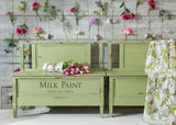 Two green benches painted in Gatineau Milk Paint by Homestead House with floral fabric seats.