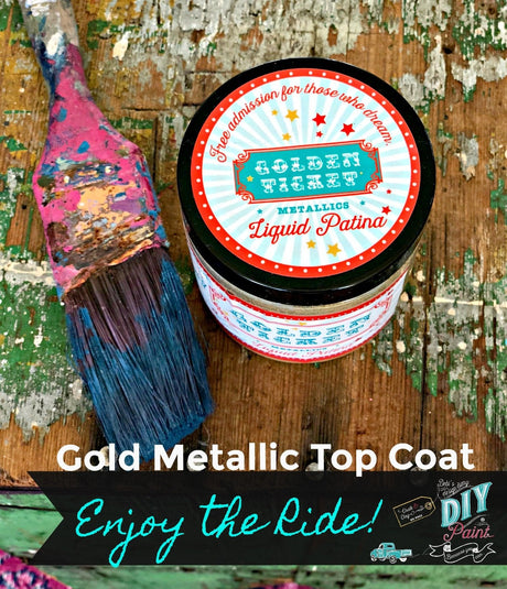 DIY Paint Co. Golden Ticket Gold Liquid Patina next to a blue-bristled paintbrush on distressed wood.