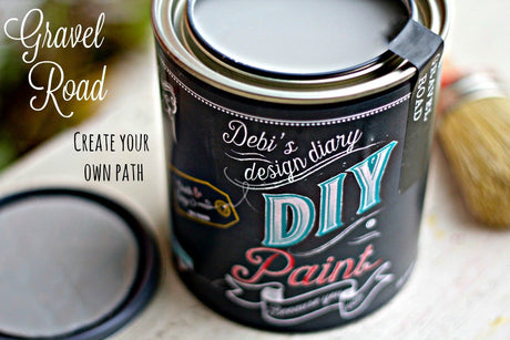 Open can of Gravel Road DIY Paint by DIY Paint Co. with lid and brush nearby; motivational text on the left.