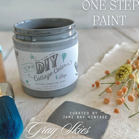 Gray Skies DIY Cottage Color by DIY Paint Co. open can with brush and dried flowers on cloth.