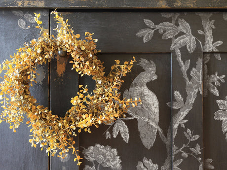 Yellow dried floral wreath on cabinet featuring I.O.D. Grisaille Toile Paint Inlay with white bird and branch motif.