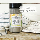 Old Fashioned Milk Paint Grit Aging Dust by Sweet Pickins displayed on a striped surface.
