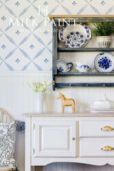 Gustavian White Milk Paint sideboard by Homestead House with blue dishes, wooden horse, and teapot on top.